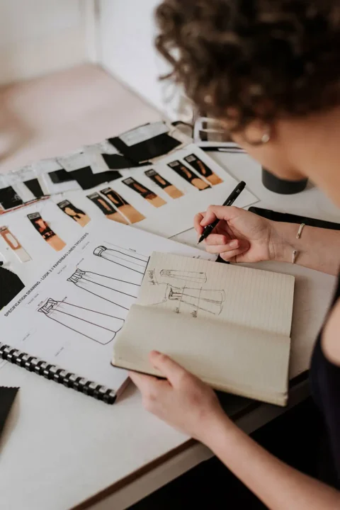 Overhead Shot Young Businesswoman Fashion Designer Reviewing Her Clothes Design Sketches